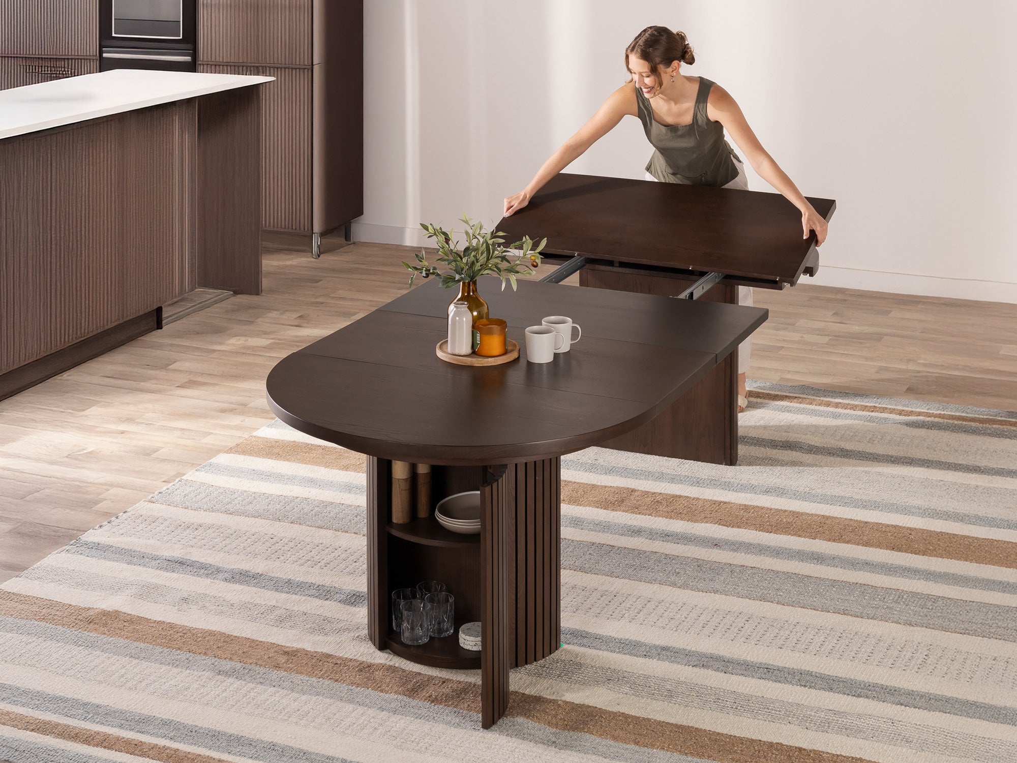Versatile expandable dining table seats 4‑10, robust hardwood‑steel build, hidden pedestal storage and elegant fluted detailing for flexible everyday dining.