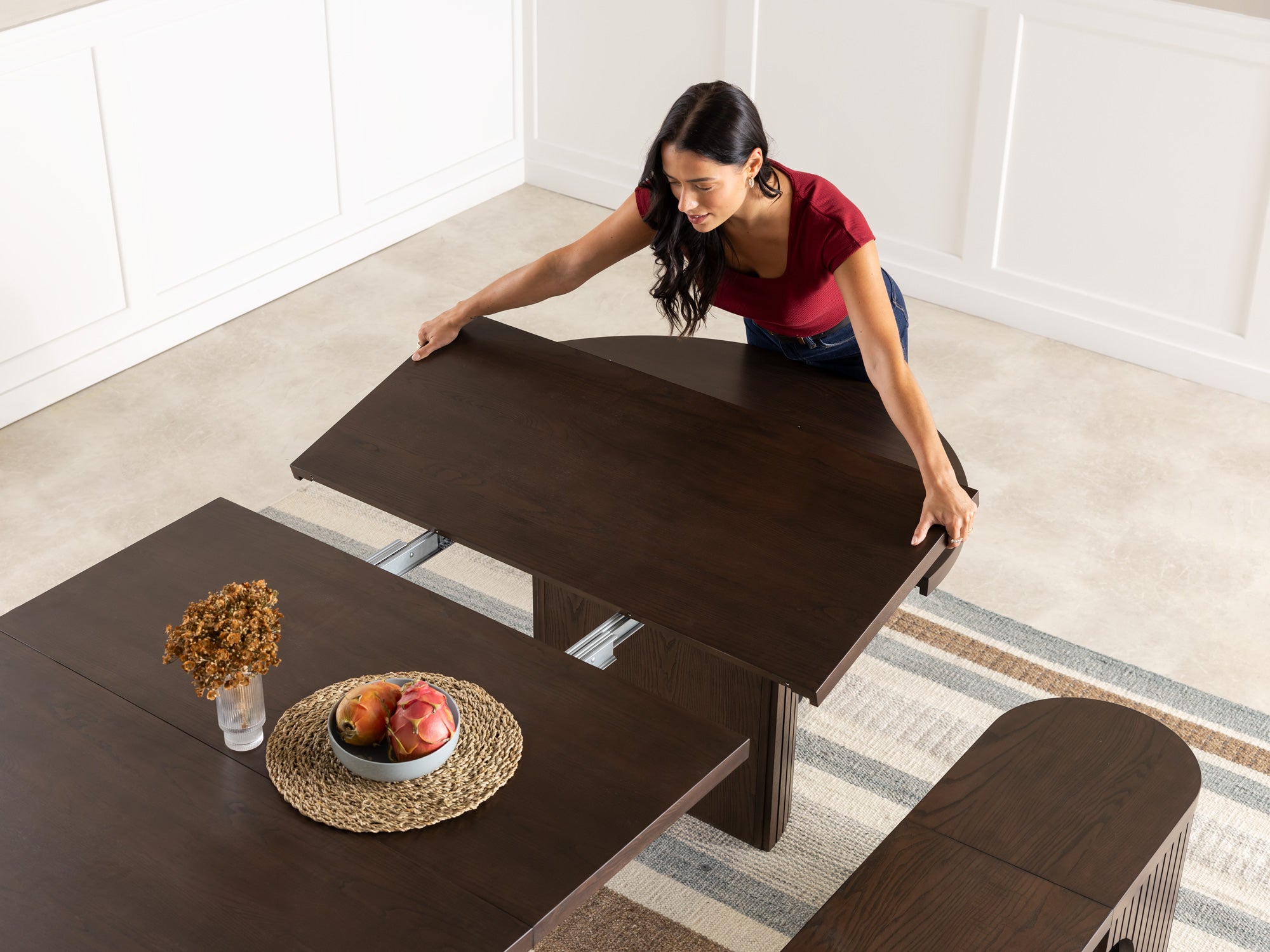 Versatile expandable dining table seats 4‑10, robust hardwood‑steel build, hidden pedestal storage and elegant fluted detailing for flexible everyday dining.