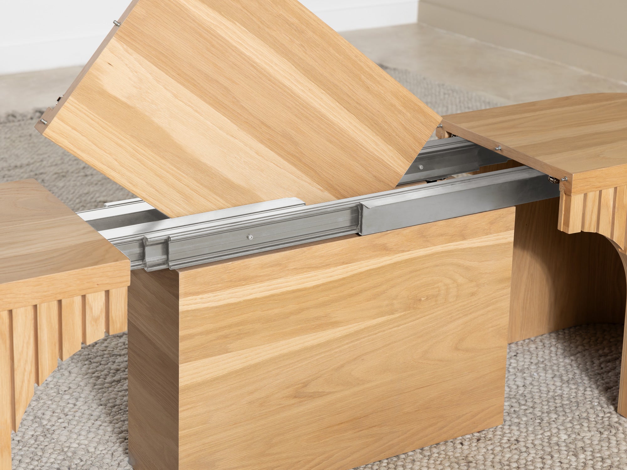 Practical extendable round dining set; storage‑built bench holds extra panels, robust hardwood build, smooth gliding rails and matching premium finishes.