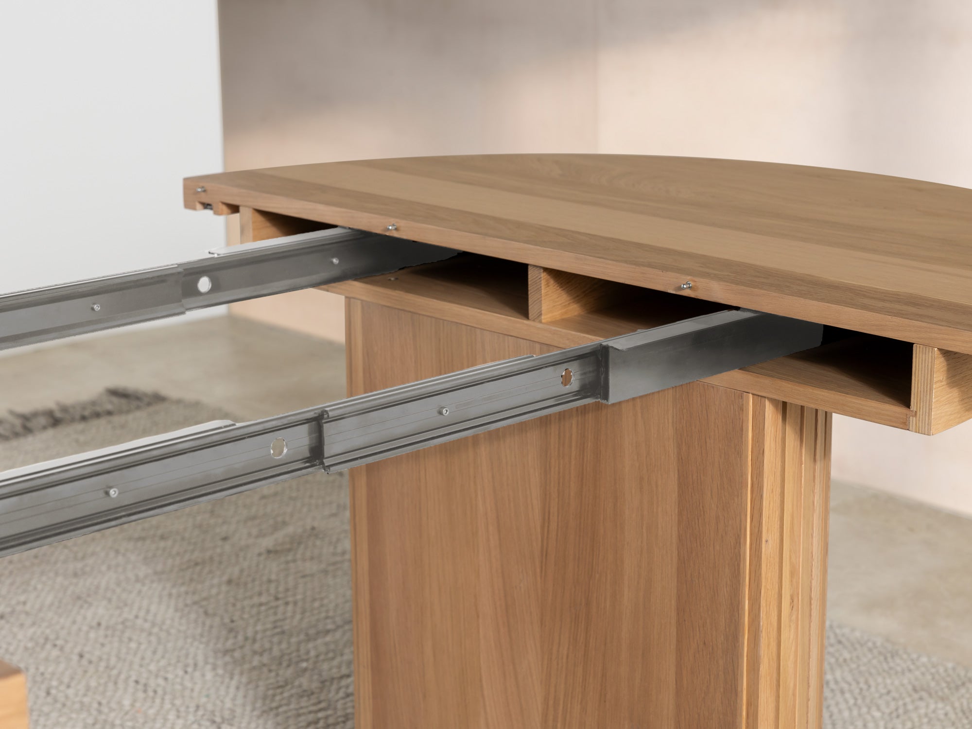 Versatile expandable dining table seats 4‑10, robust hardwood‑steel build, hidden pedestal storage and elegant fluted detailing for flexible everyday dining.