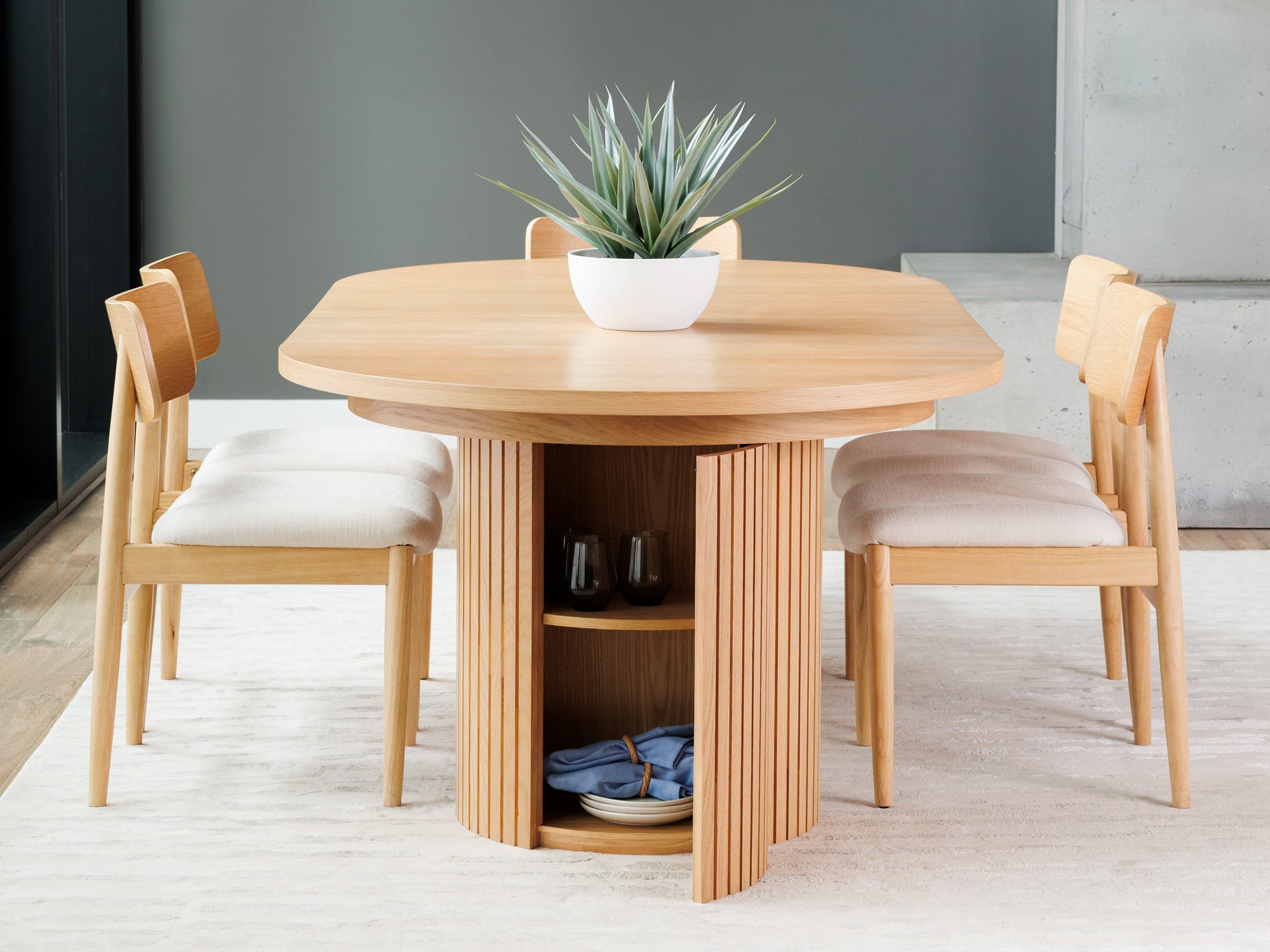 Versatile expandable dining table seats 4‑10, robust hardwood‑steel build, hidden pedestal storage and elegant fluted detailing for flexible everyday dining.