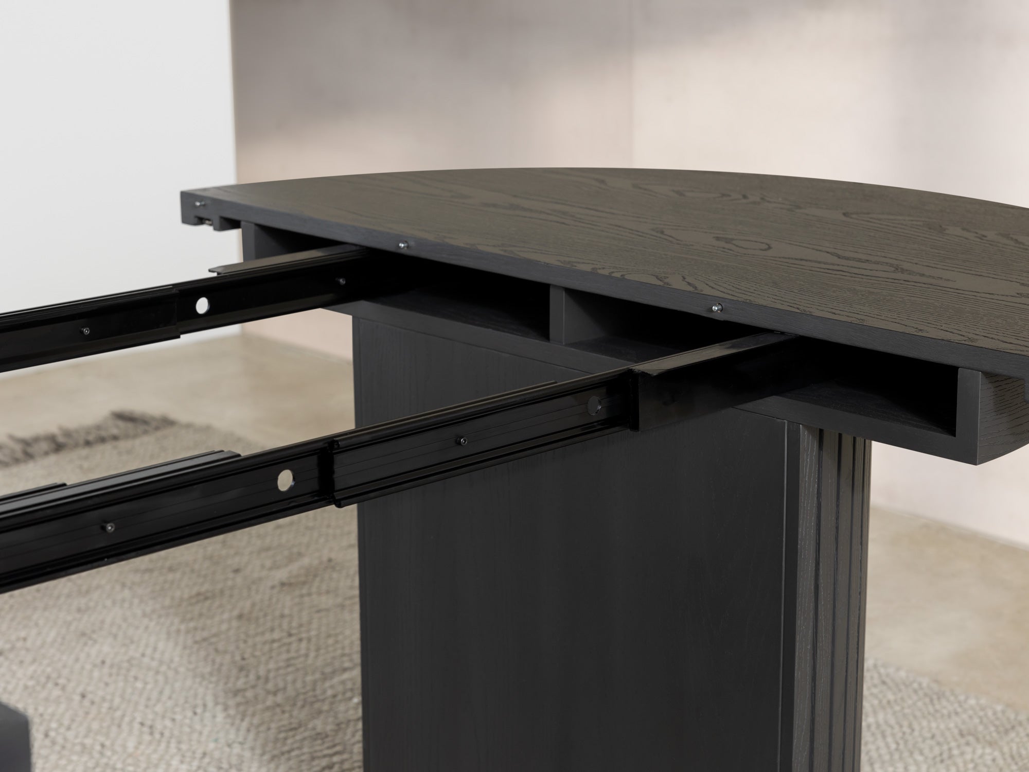 Versatile expandable dining table seats 4‑10, robust hardwood‑steel build, hidden pedestal storage and elegant fluted detailing for flexible everyday dining.