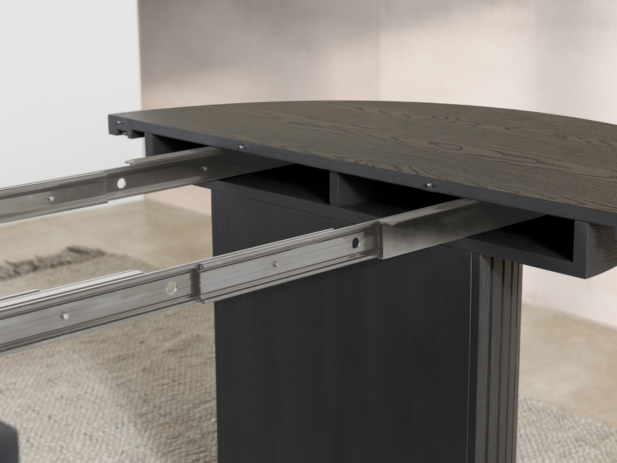 Versatile expandable dining table seats 4‑10, robust hardwood‑steel build, hidden pedestal storage and elegant fluted detailing for flexible everyday dining.