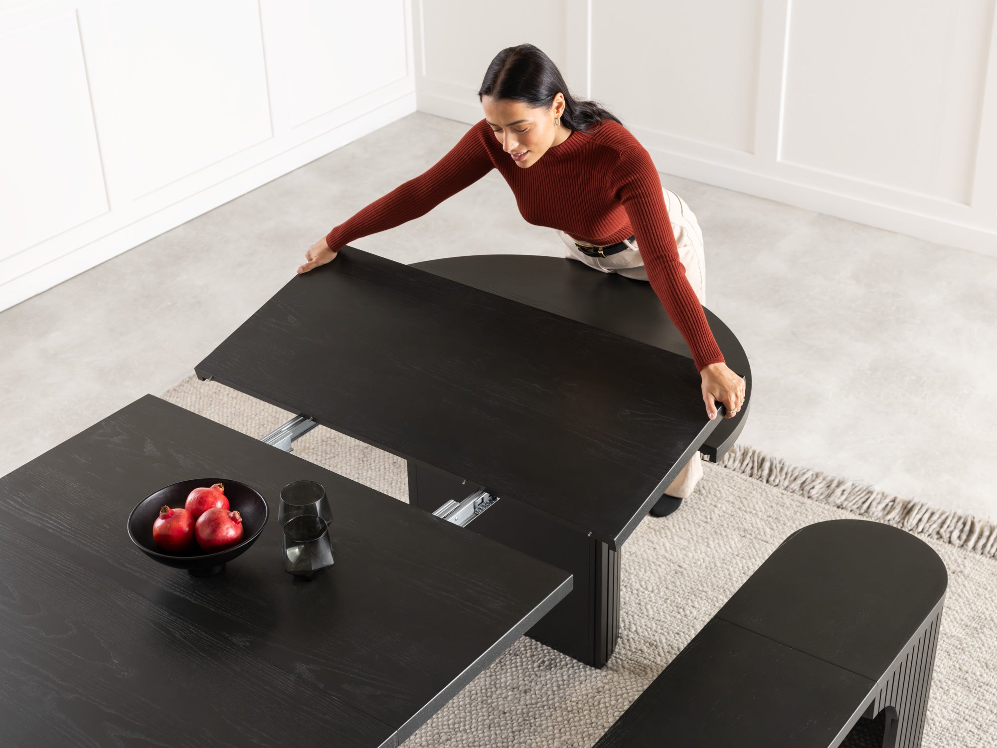 Versatile expandable dining table seats 4‑10, robust hardwood‑steel build, hidden pedestal storage and elegant fluted detailing for flexible everyday dining.