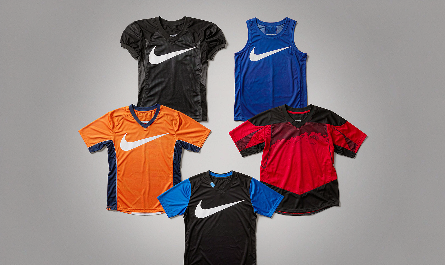 Flat lay of folded football, basketball, baseball, hockey and soccer jerseys
