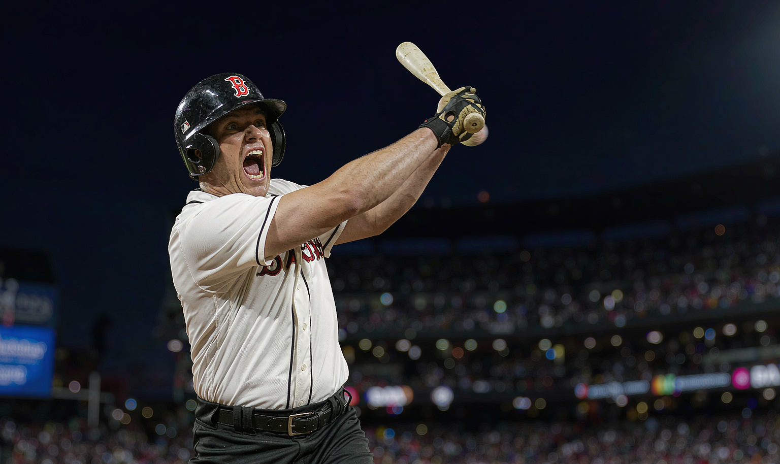 Baseball batter driving a fastball deep in a night game