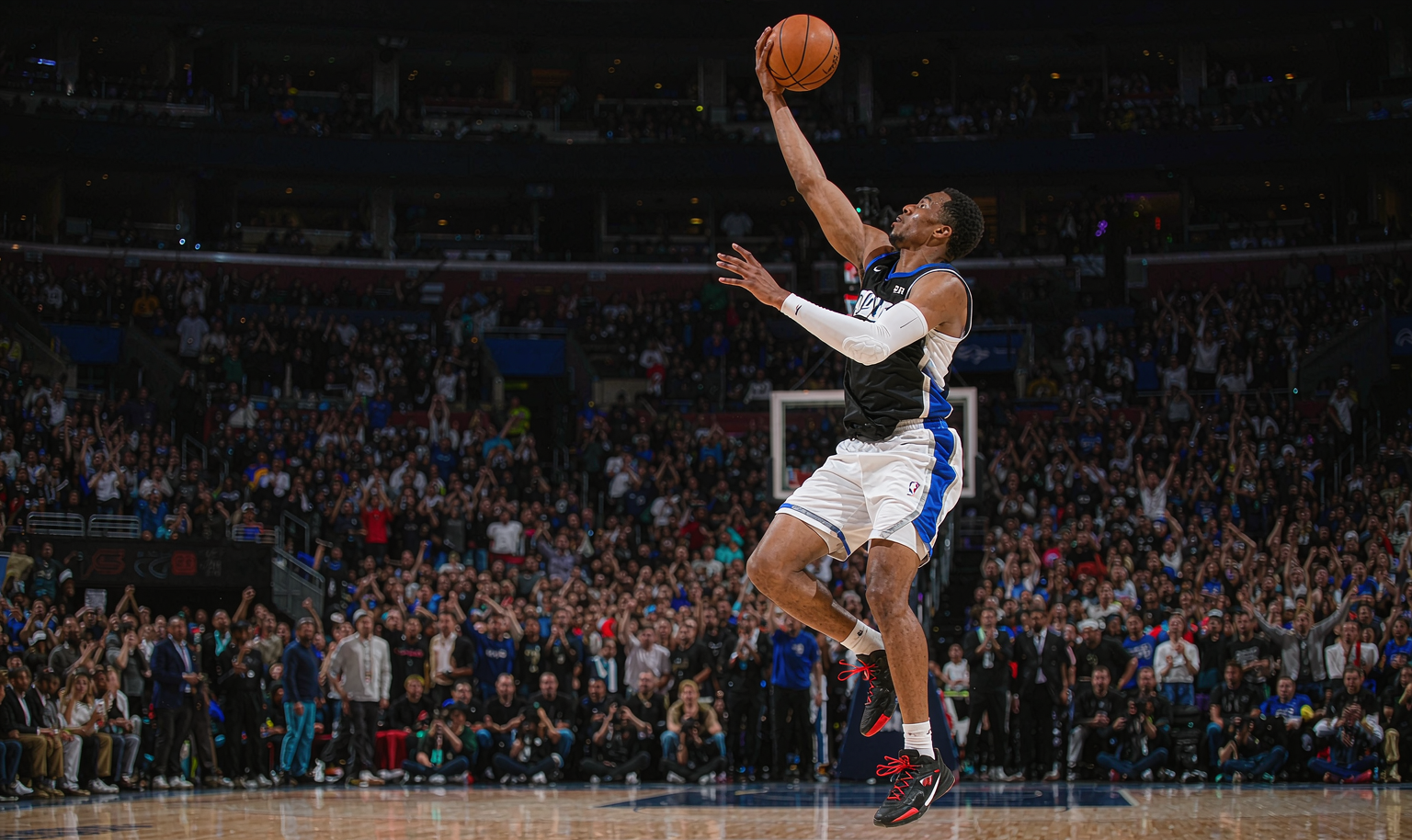 NBA guard rising for a two-hand dunk under arena lights