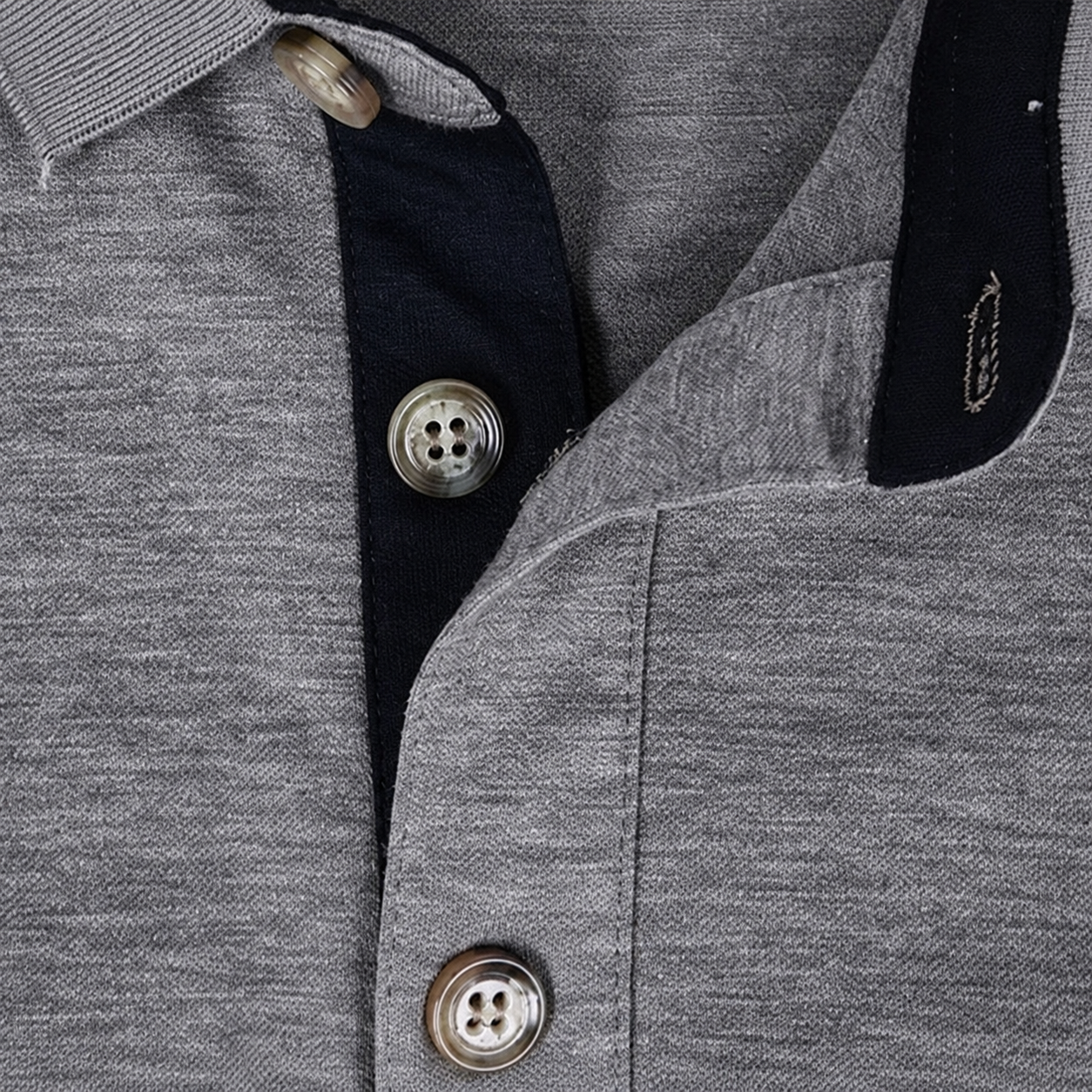 Close-up of polo buttons, buttonholes and inner placket