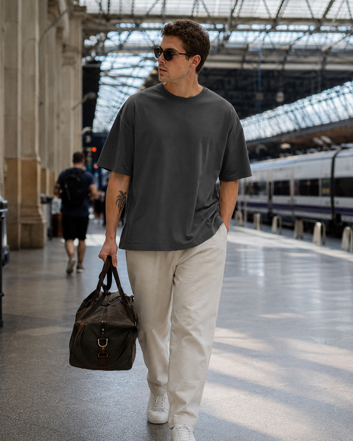 Sage green oversized T-shirt at a relaxed coffee shop patio