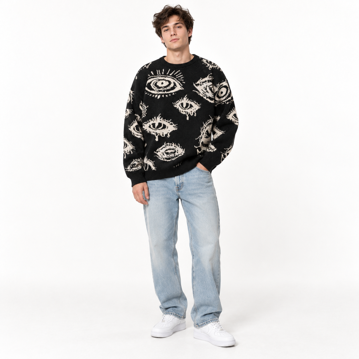 Young male model wearing Black eye graphic sweater in a clean studio, front view