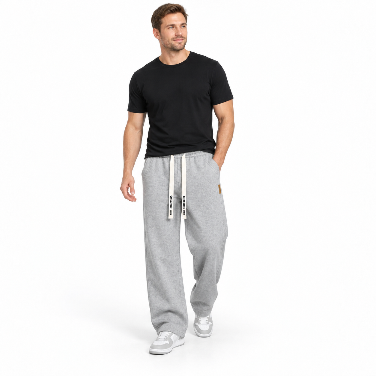 Man wearing Heather Grey heavyweight loose straight-leg drawstring pants, studio front view