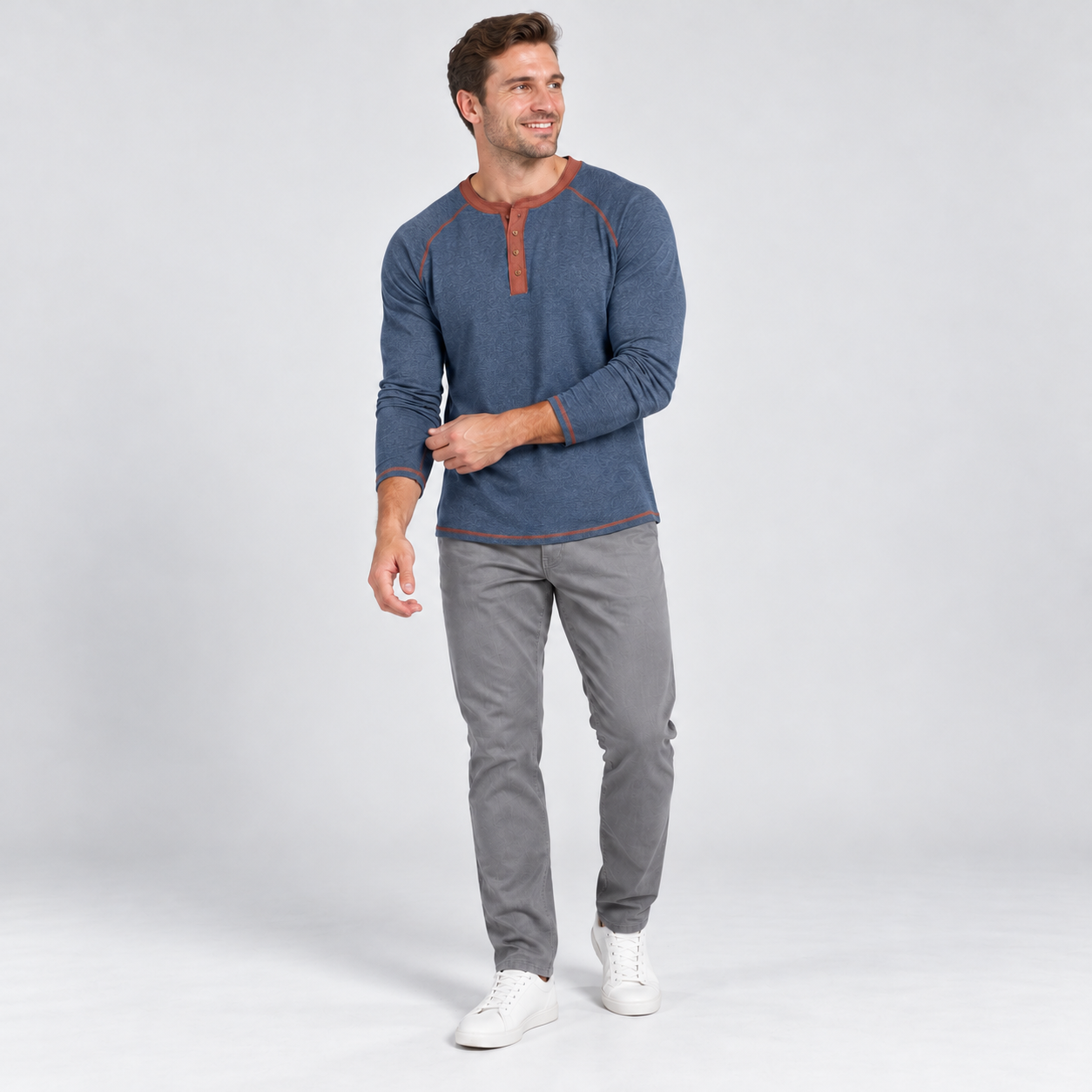 Man wearing the Denim Blue Heather four-button raglan Henley shirt, clean studio front view