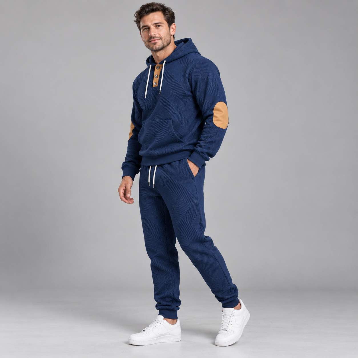 Model wearing the Treasure Blue textured two-piece hoodie and jogger tracksuit in a full-body studio view