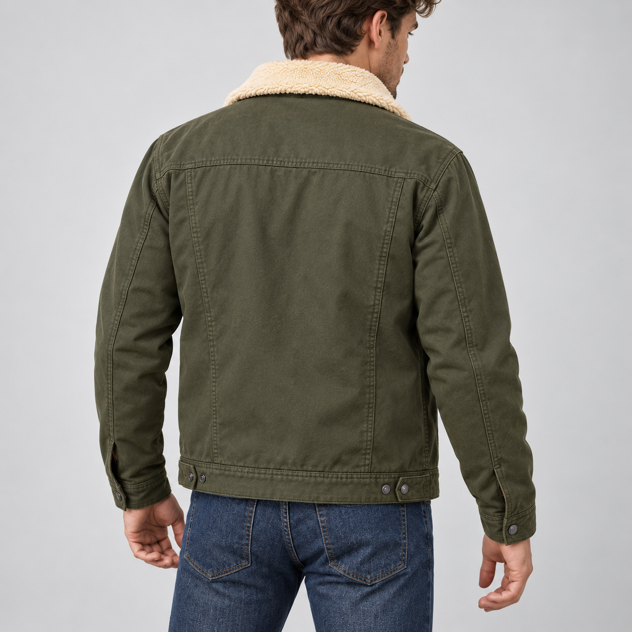 Young American male model wearing Olive Green sherpa-lined workwear trucker jacket, back three-quarter studio view