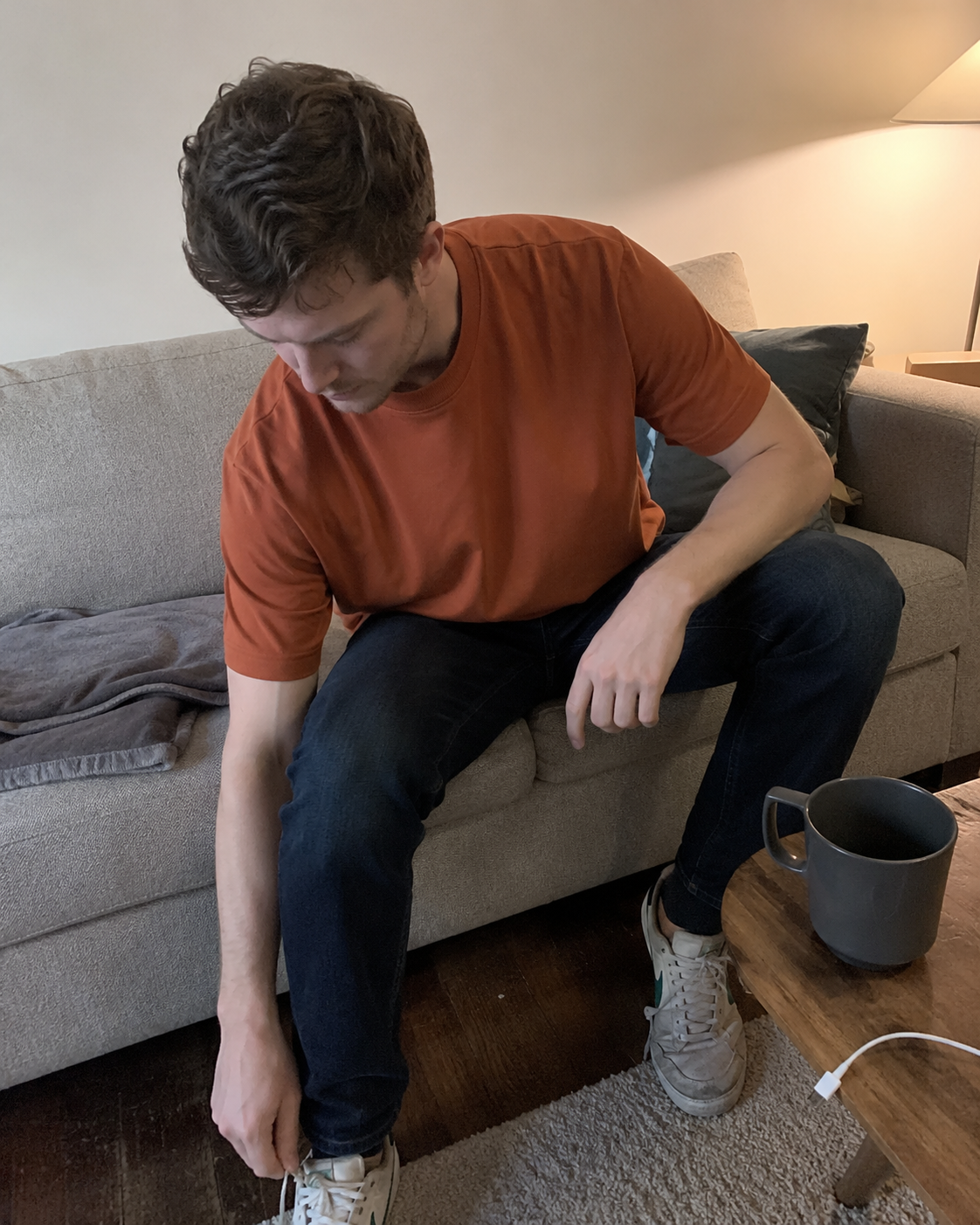 Rust loose-fit crew-neck T-shirt in a relaxed home setting