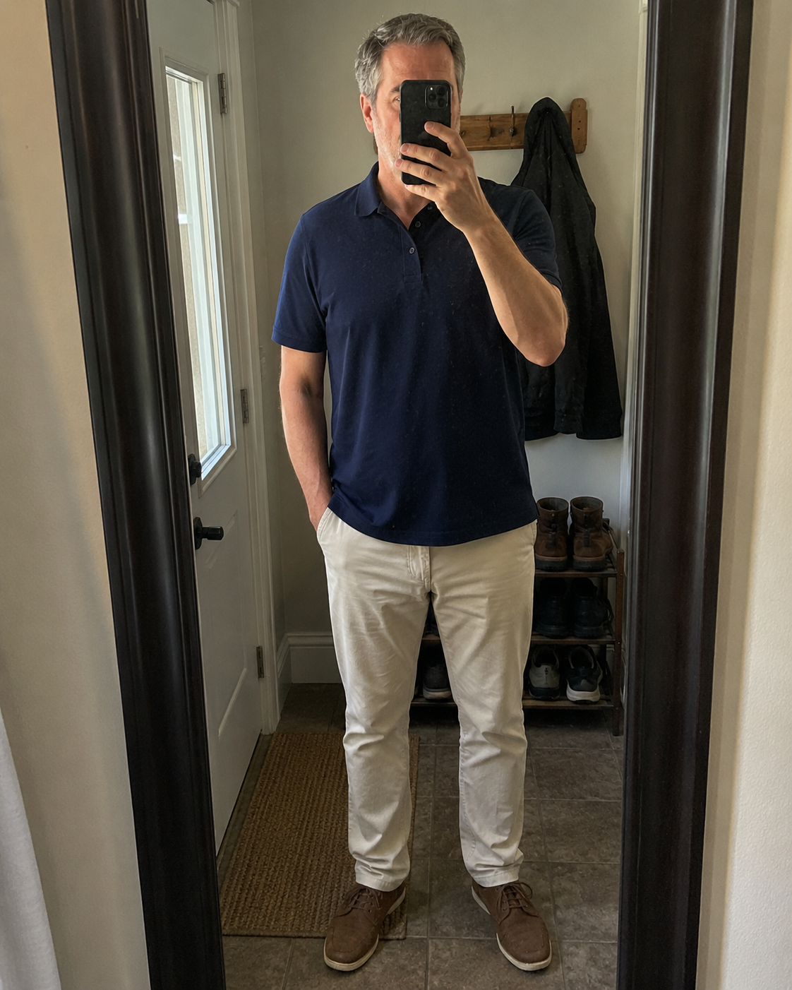 Navy pique polo in a casual mirror-style photo