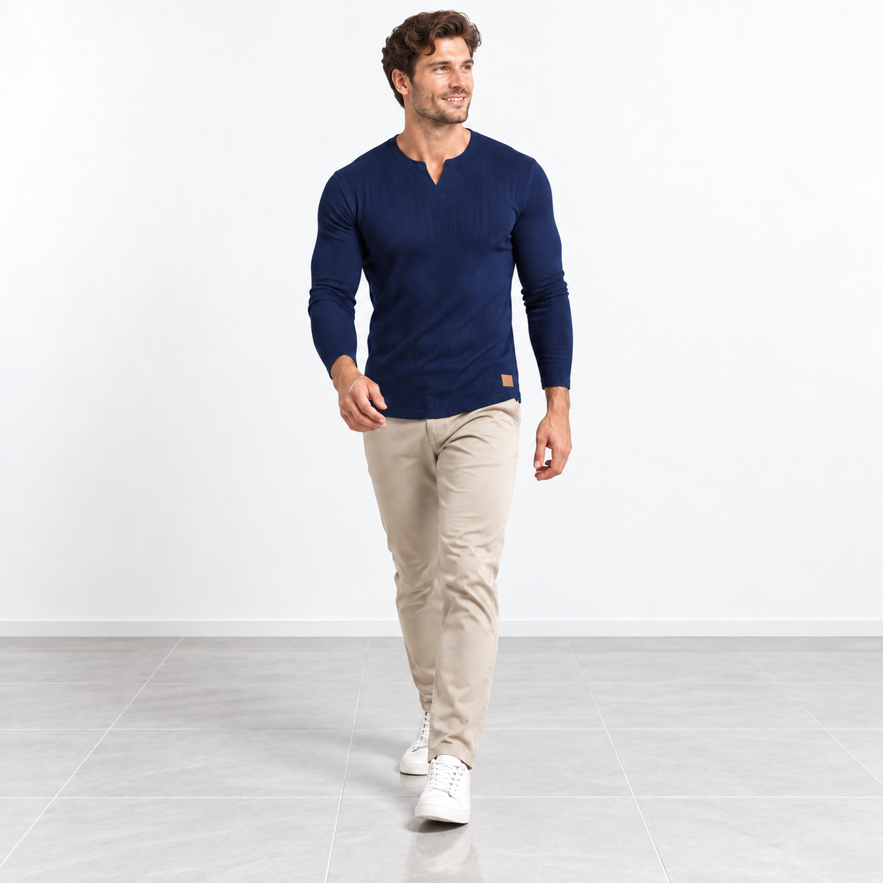 Male model wearing Navy Blue slim-fit long-sleeve ribbed V-neck T-shirt, moving studio view