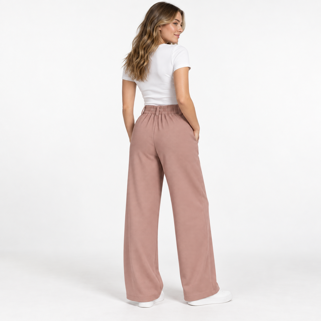 Female model showing the elasticized back waist of Rose Tan waffle wide-leg work pants