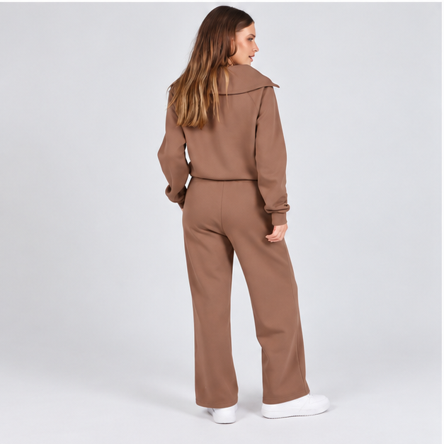Woman wearing the Mocha Brown half-zip top and wide-leg pants set, studio back view