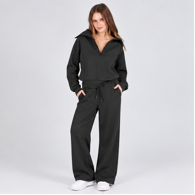 Woman wearing the Jet Black half-zip top and wide-leg pants set, studio front view