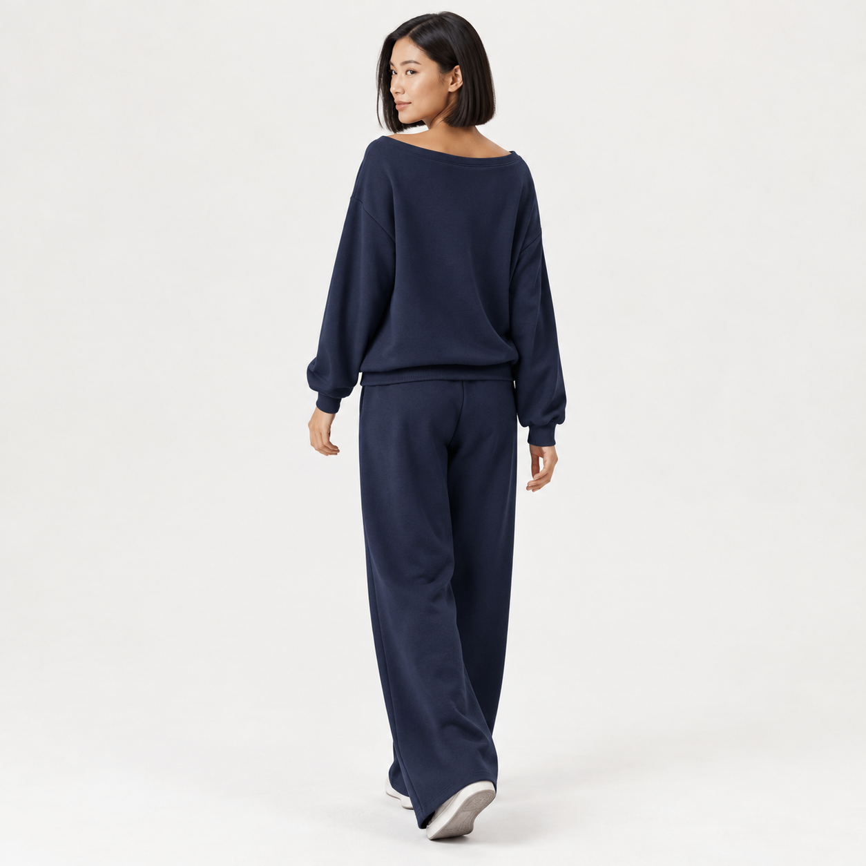 Woman wearing Navy off-shoulder wide-leg lounge set, clean studio back view
