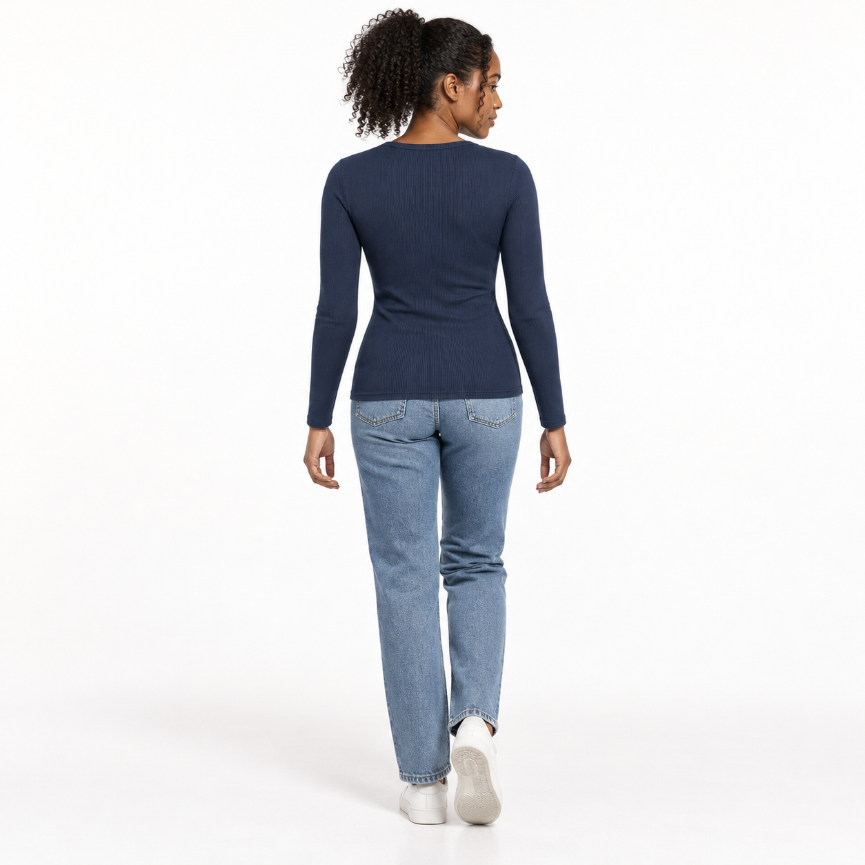 Woman wearing the Navy Blue ribbed fitted long-sleeve crewneck top, studio back view