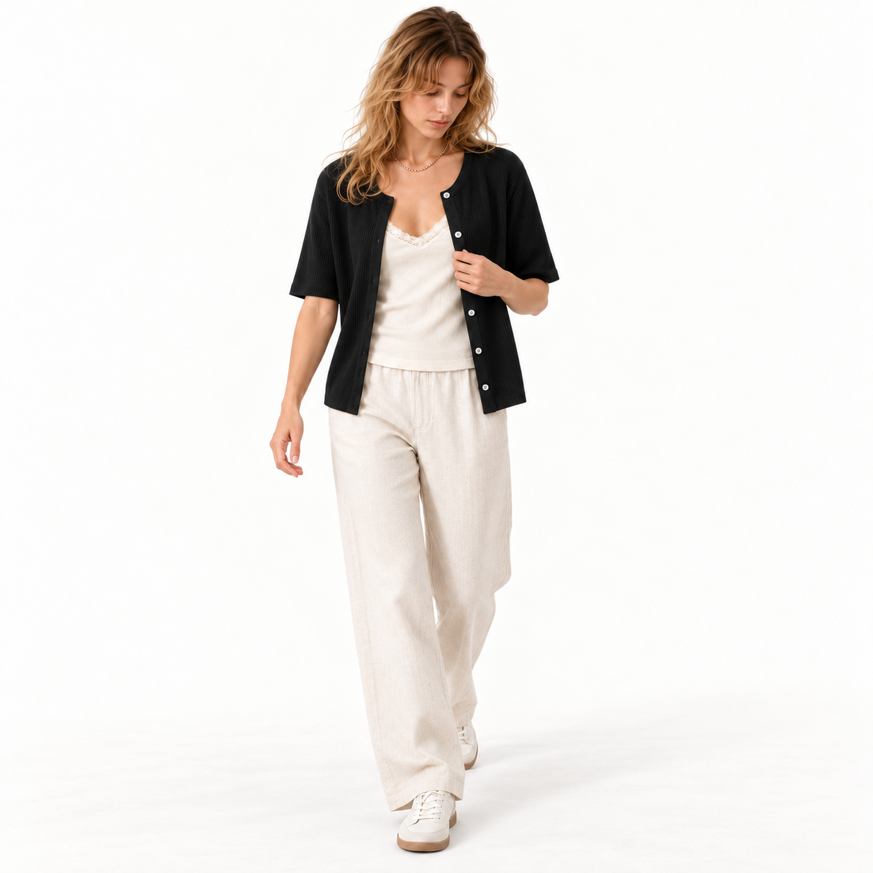 Woman wearing the Black short-sleeve ribbed cardigan open, studio front view