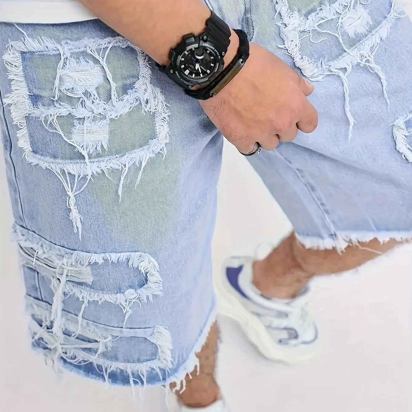 Distressed raw-edge denim shorts with slight stretch; pants without a drawstring