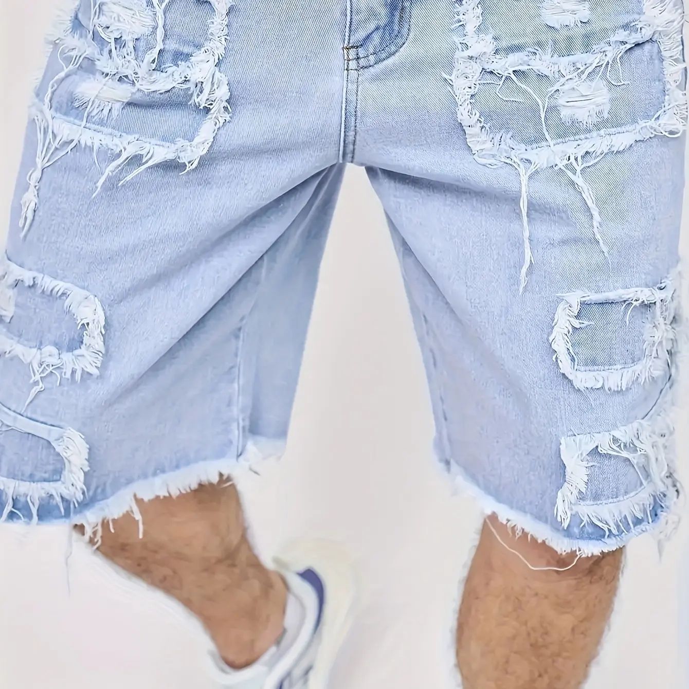 Distressed raw-edge denim shorts with slight stretch; pants without a drawstring