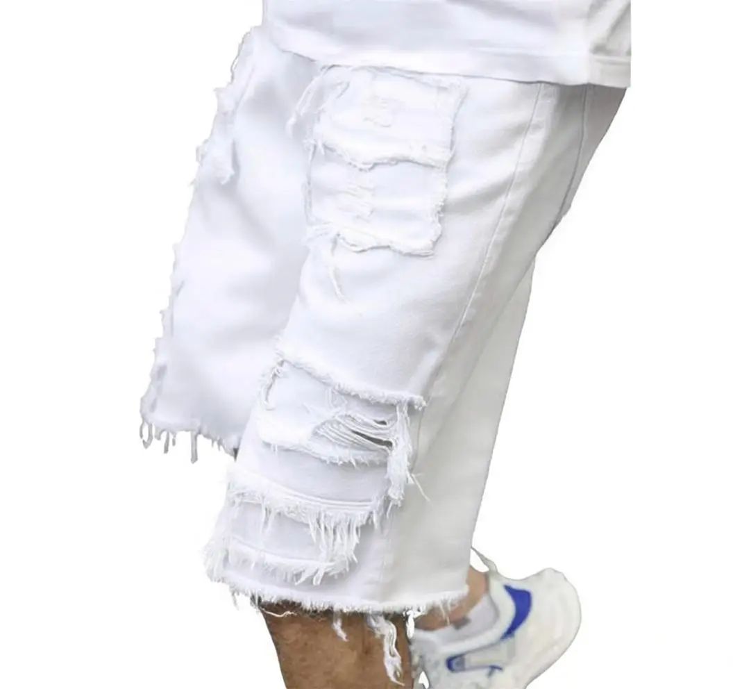 Distressed raw-edge denim shorts with slight stretch; pants without a drawstring