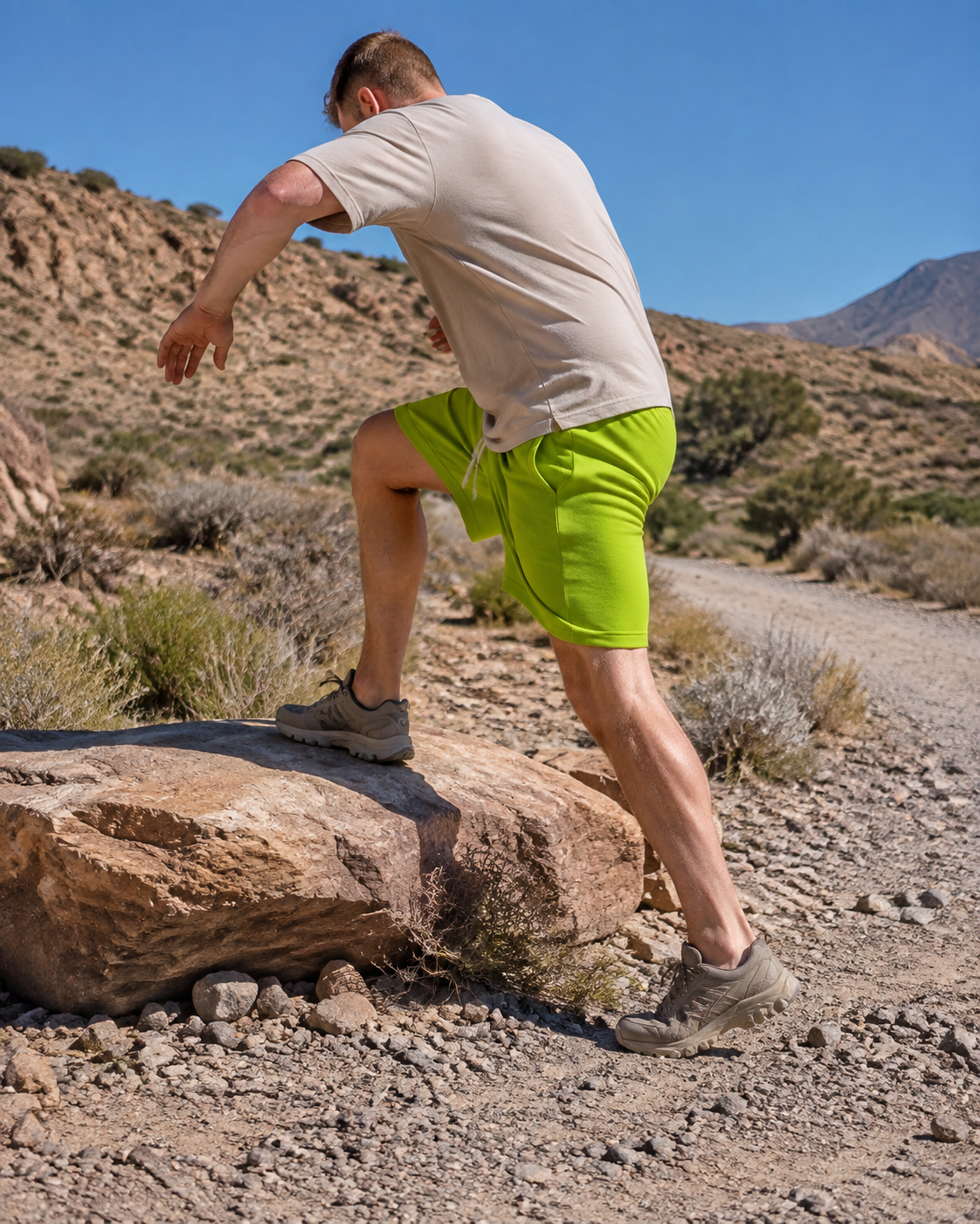 Man wearing lime green drawstring shorts on a rocky trail