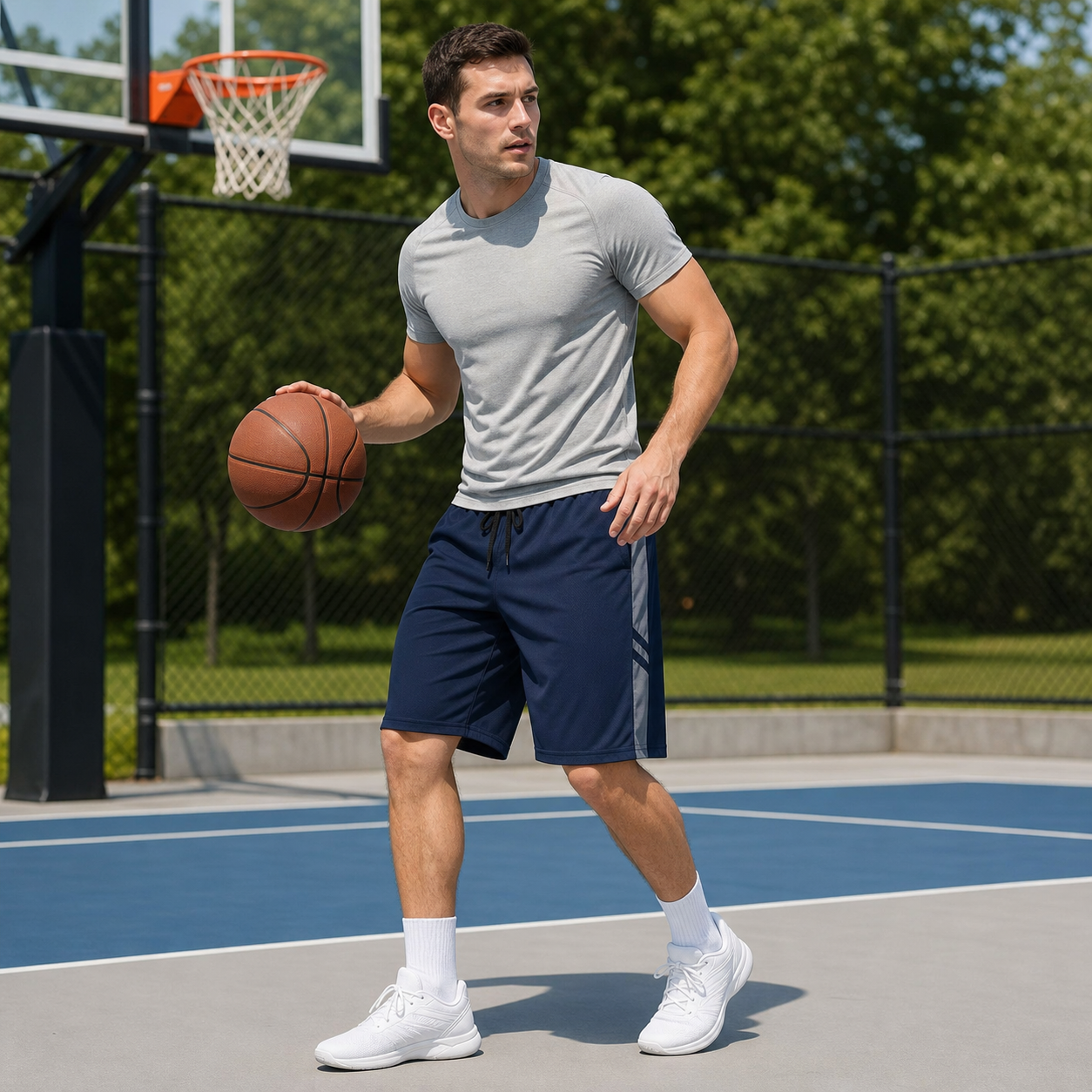 Man wearing navy mesh athletic shorts while playing basketball outdoors