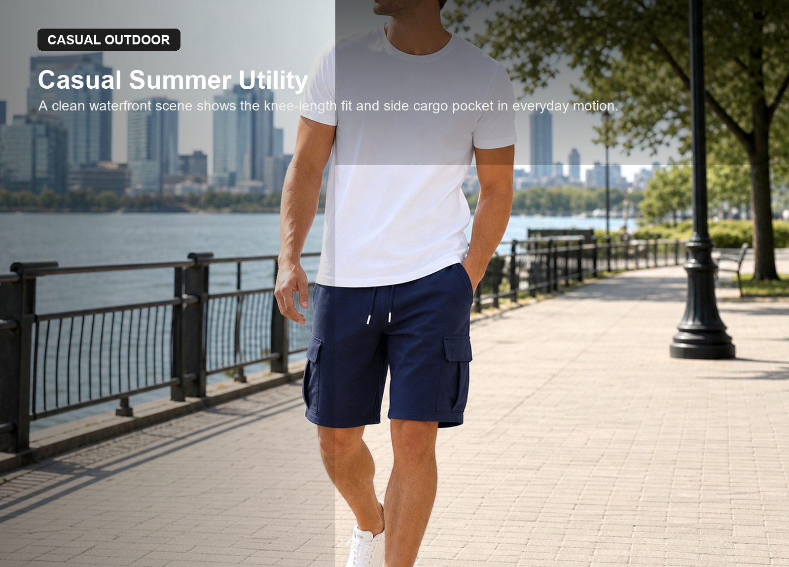 Man wearing navy drawstring cargo sweat shorts on a waterfront walk