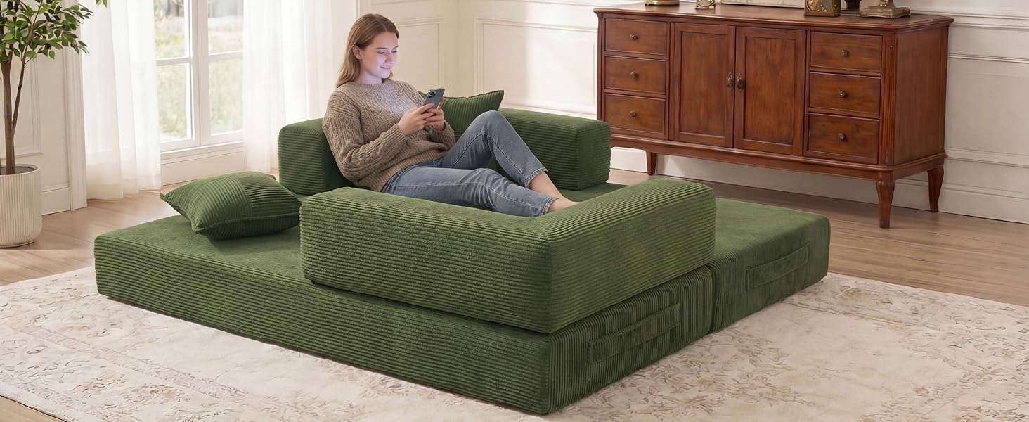 Green modular sofa bed in a modern living room