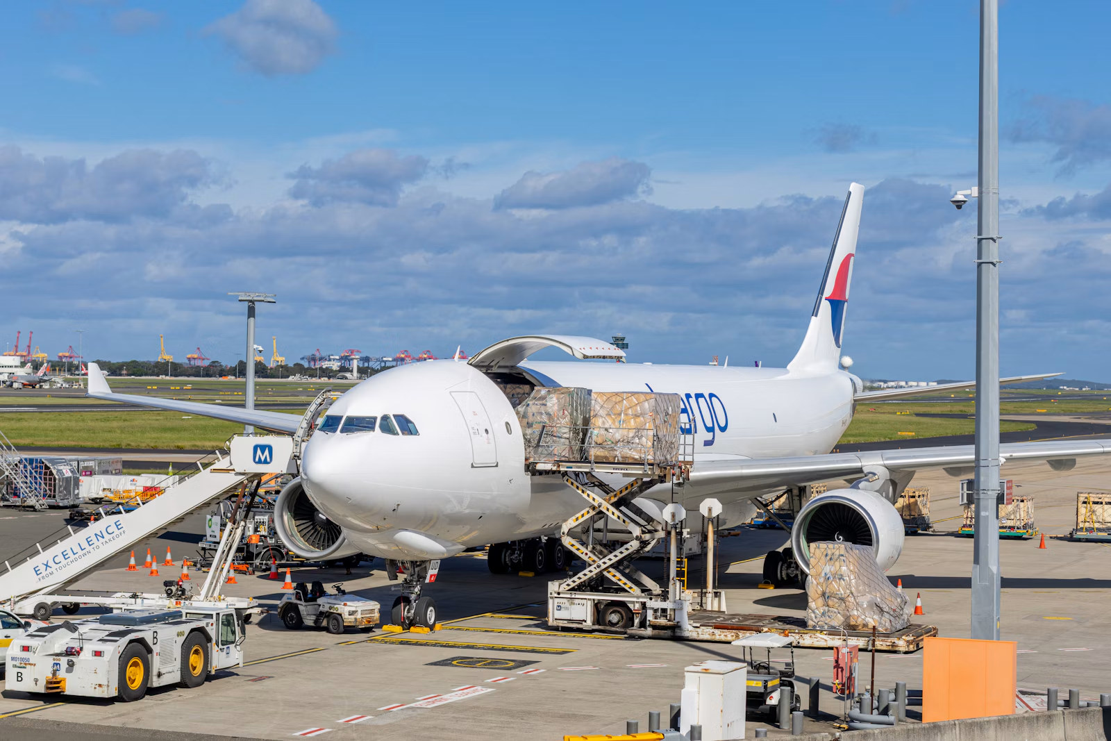 Cargo aircraft loading freight at airport