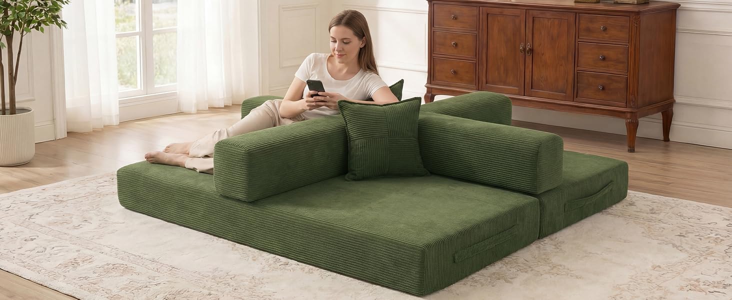 Green convertible corduroy sofa bed in a bright modern living room
