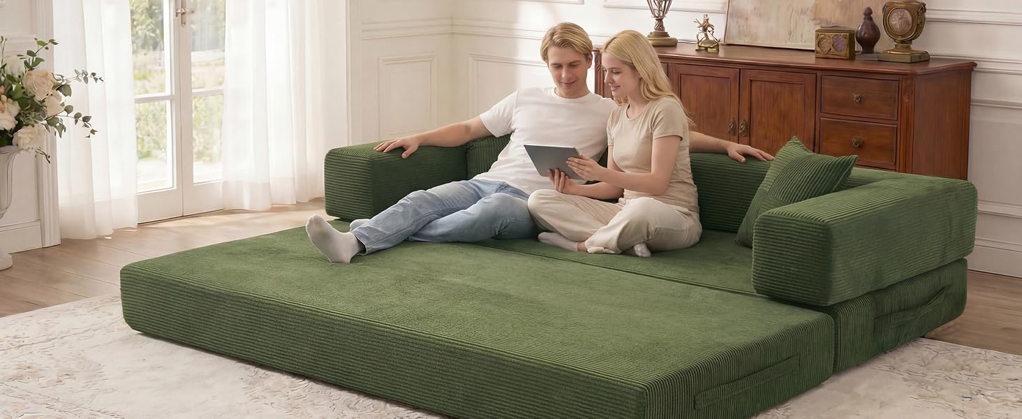 Convertible green sofa bed shown in use