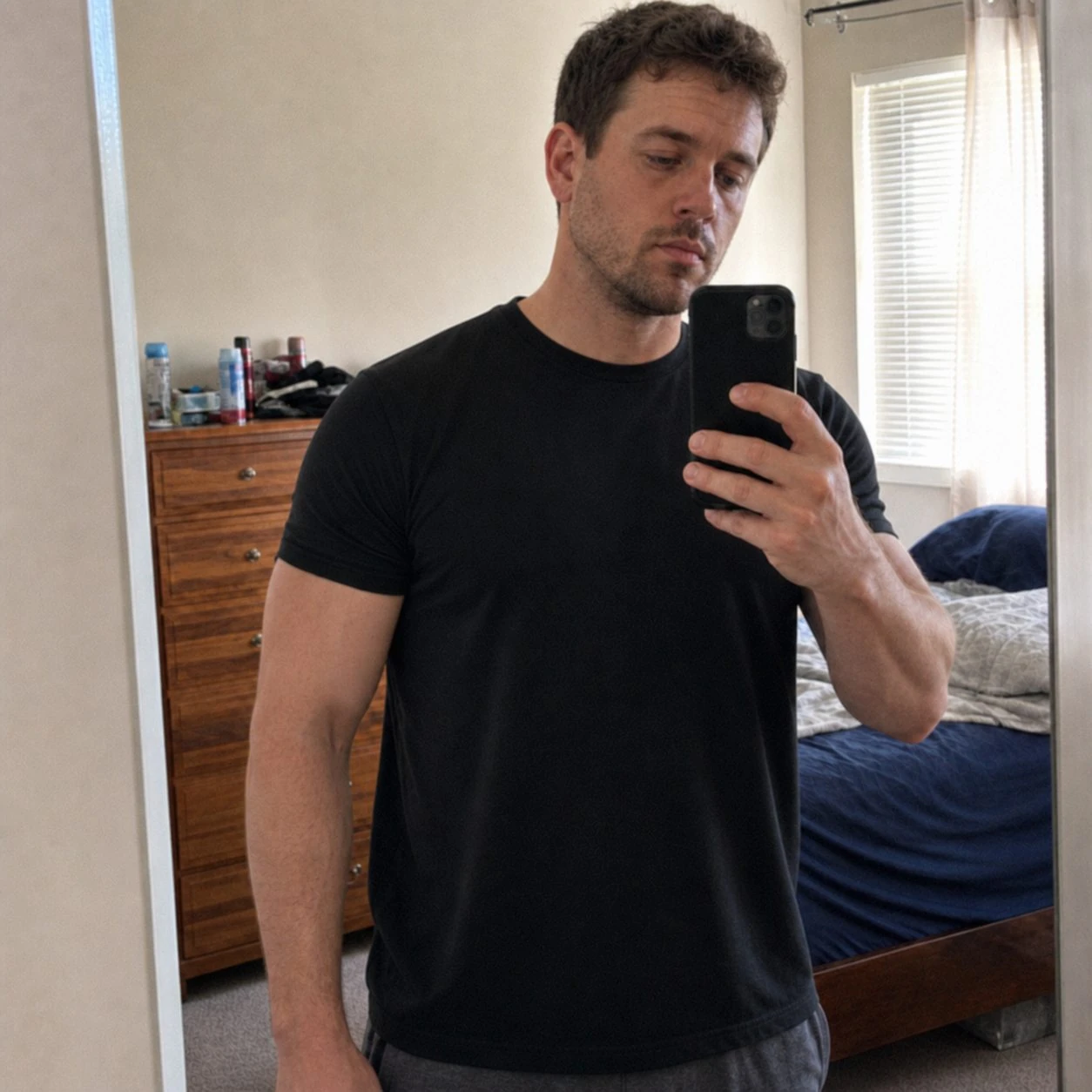 Casual phone snapshot of the T-shirt in a bedroom