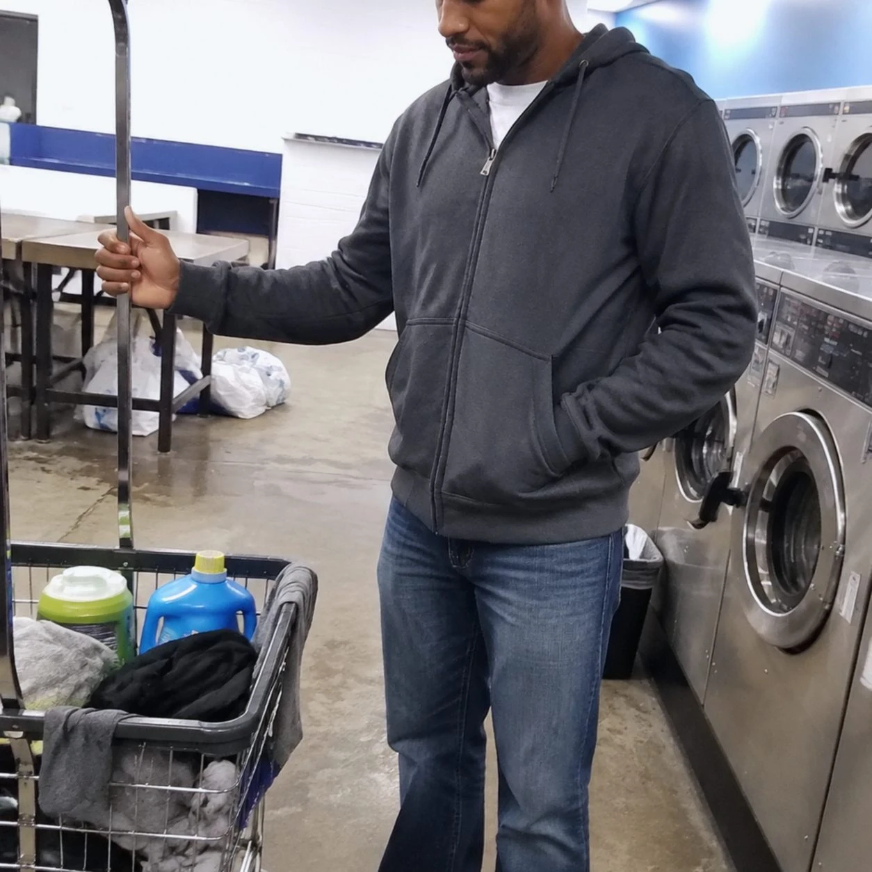 Charcoal full-zip hoodie in a neighborhood laundromat phone photo
