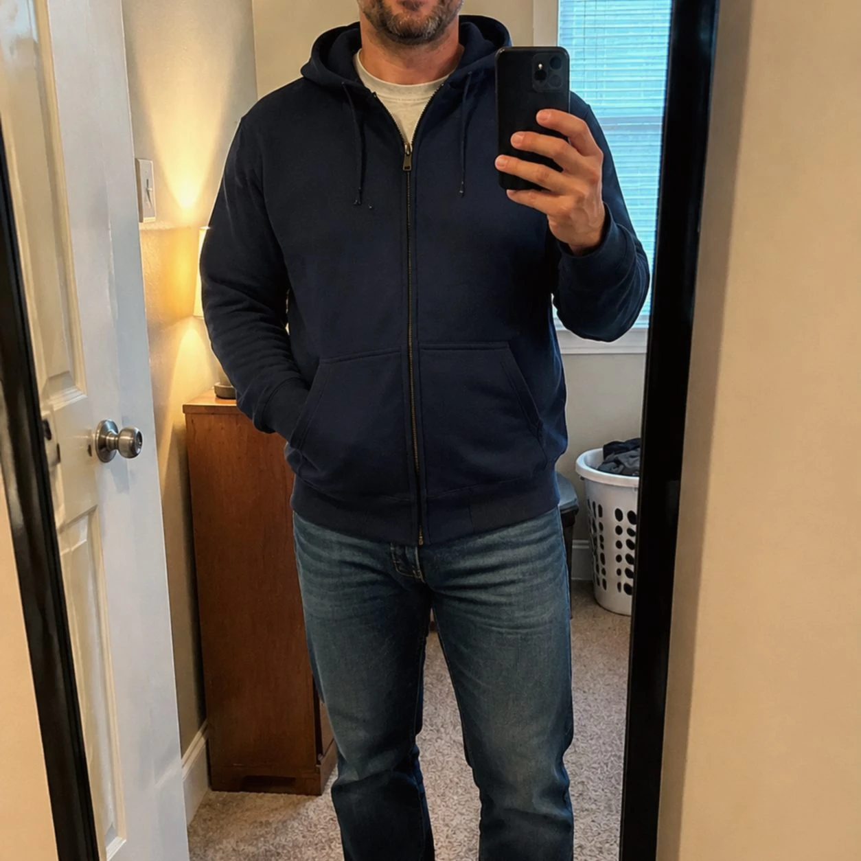 Navy full-zip hoodie in an ordinary bedroom mirror phone photo