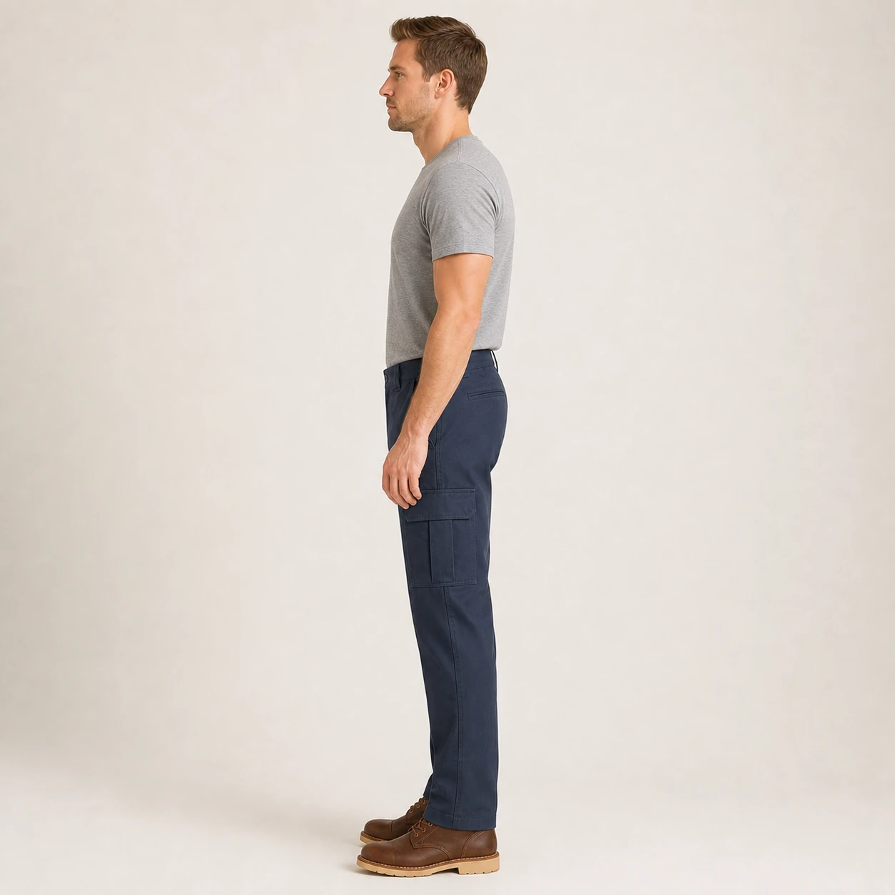 Side view of the same model wearing Dark Navy cargo work pants