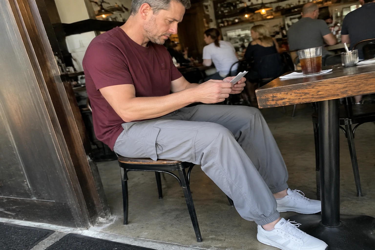 Moonlight Gray parachute cargo pants shown in a casual cafe photo