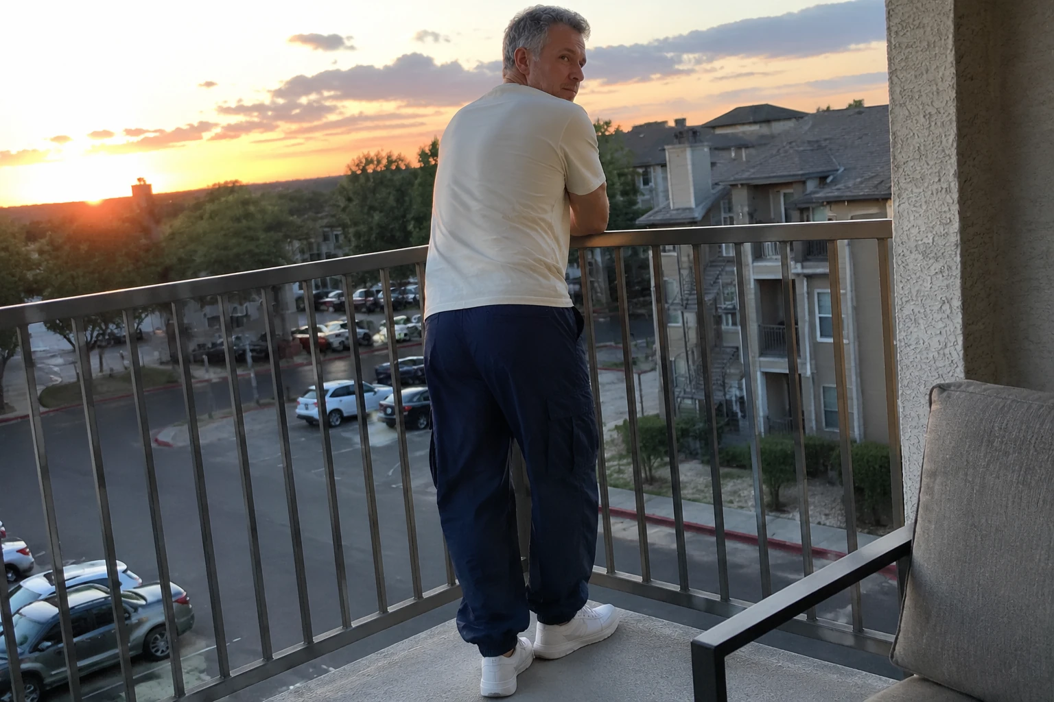 Back view of Navy parachute cargo pants on a balcony
