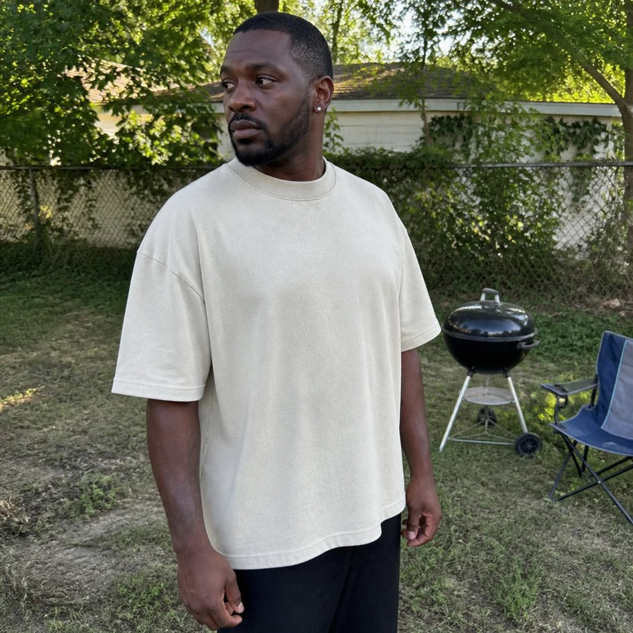 Casual phone snapshot of Off White T-shirt in a backyard