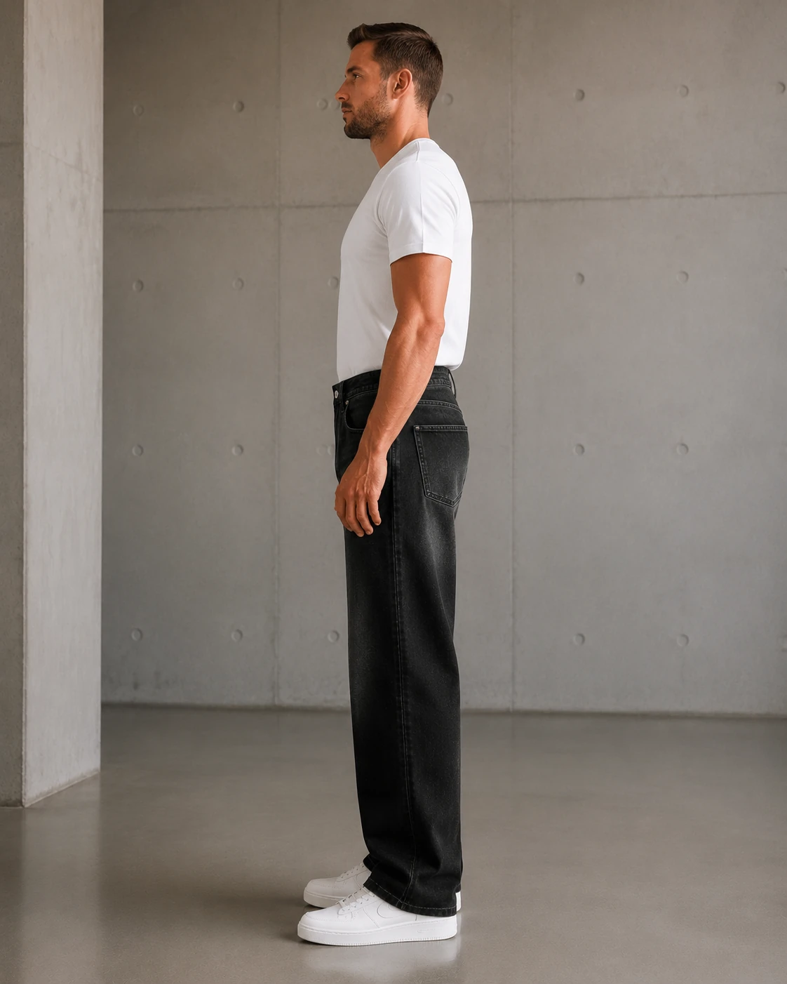 Side fit view of black-gray vintage washed jeans