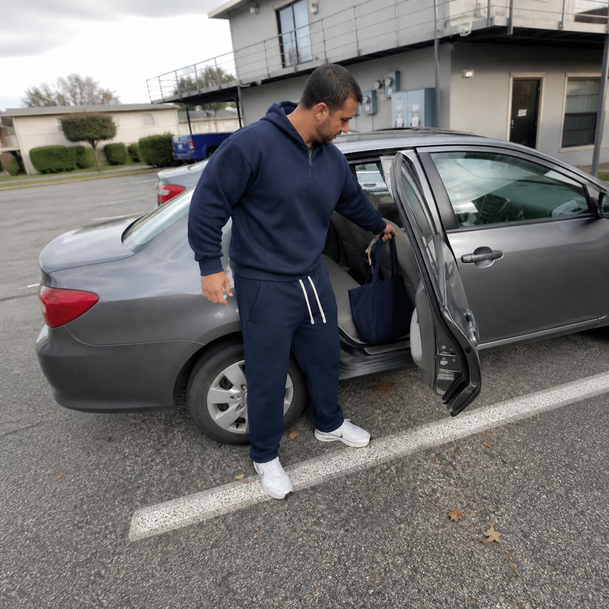 Navy sweatsuit in an ordinary apartment parking phone photo