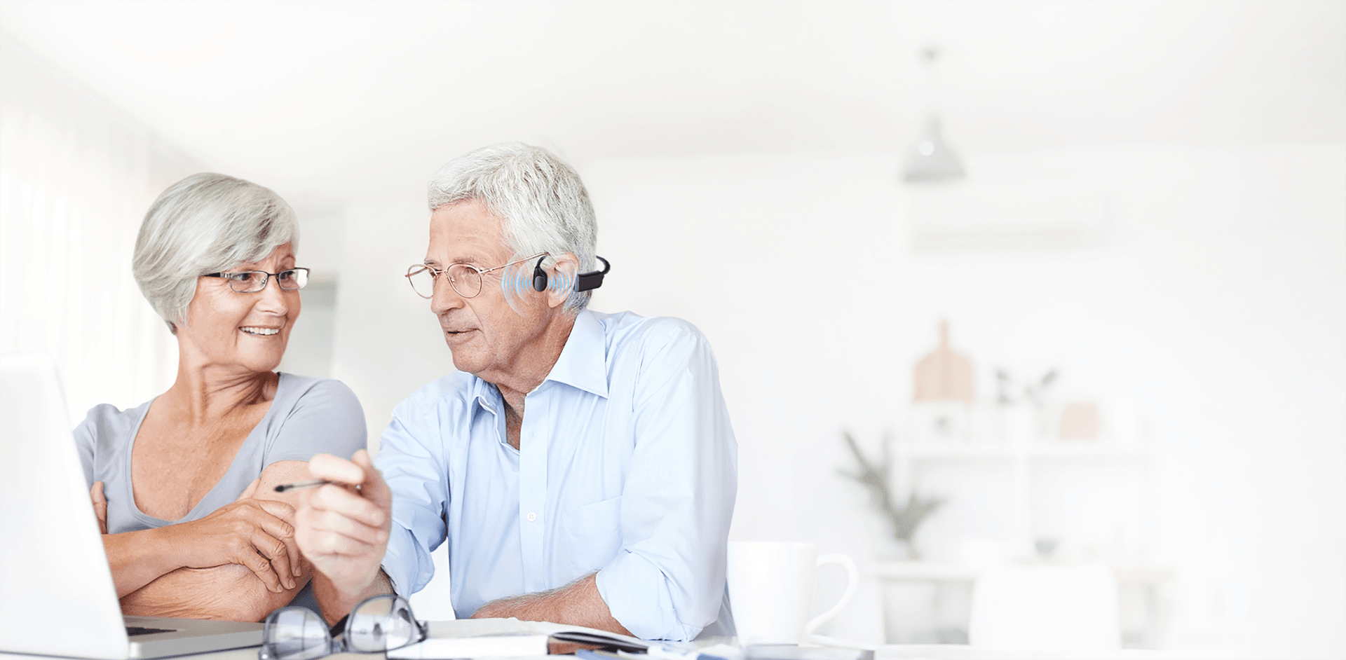 Older couple communicating comfortably with open-ear bone conduction hearing technology