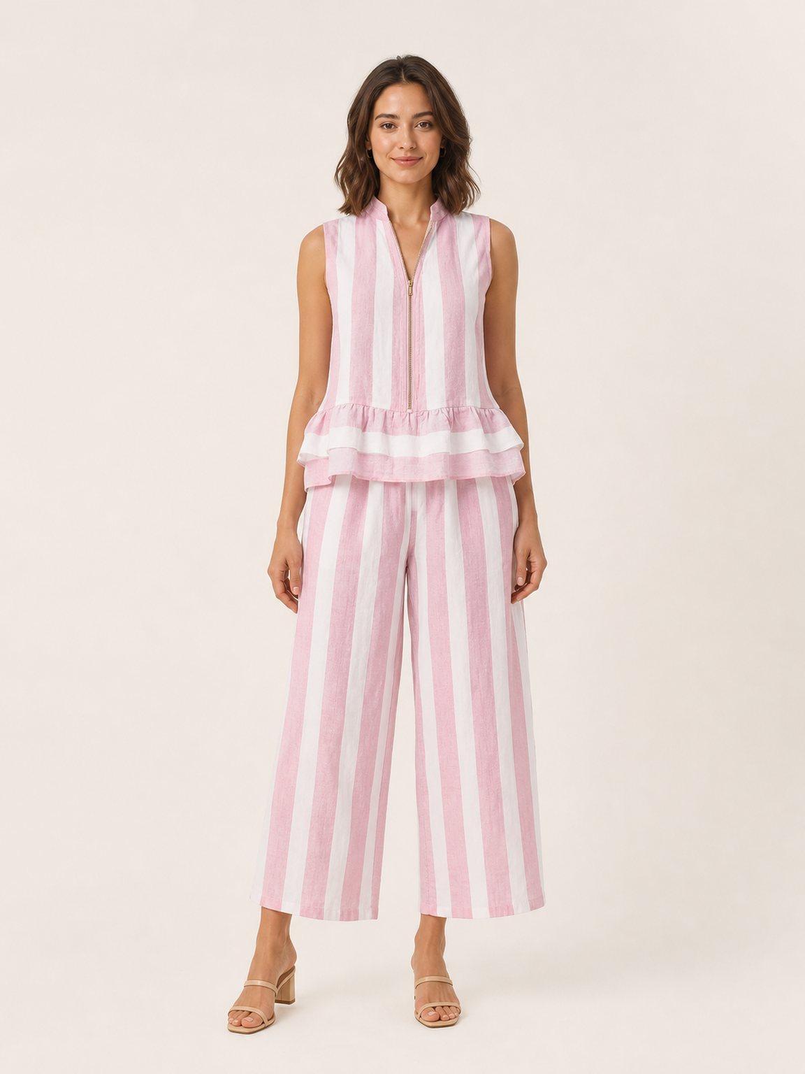 Front view of women's blush pink striped zip peplum wide-leg set