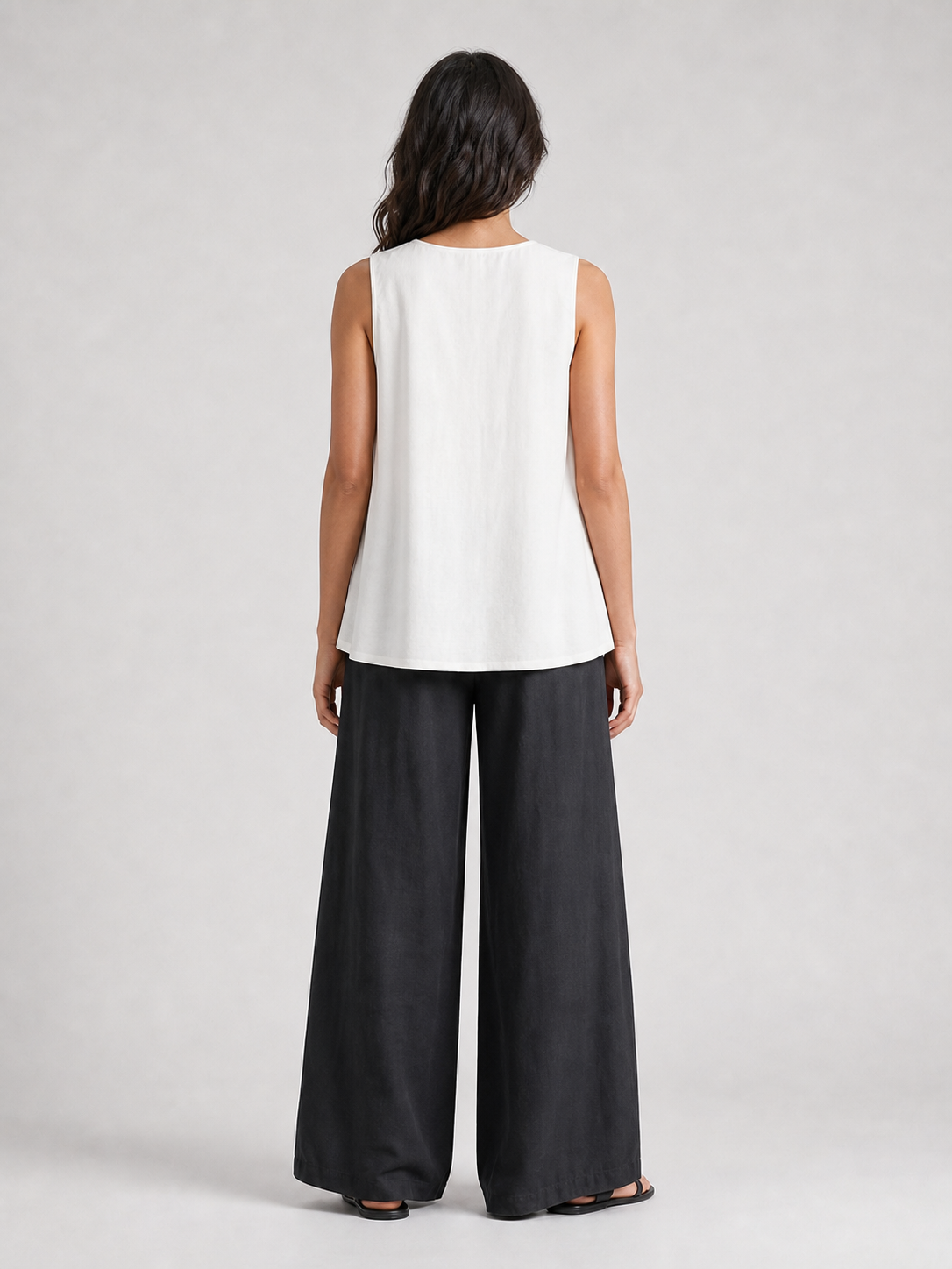 Women's soft white pleated sleeveless A-line top back view