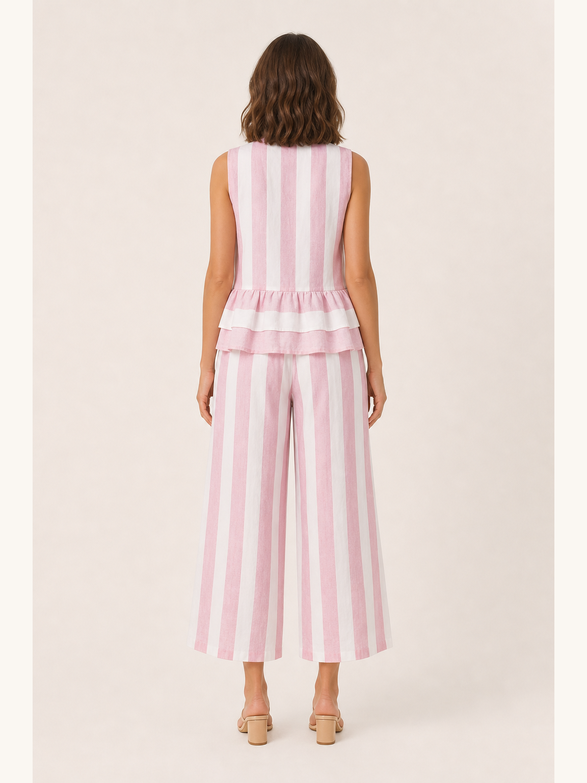 Back view of women's blush pink striped peplum wide-leg set